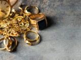 Old and broken jewelry, vintage watches on dark background. Sell gold for cash concept.