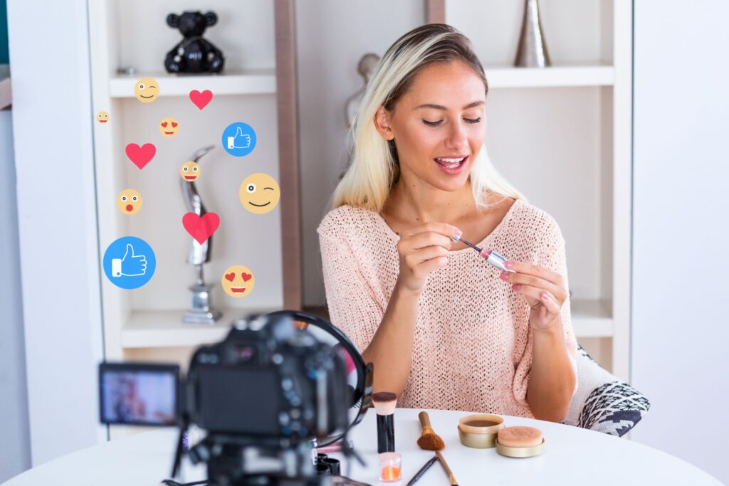 Influencer presenting makeup product in front of a camera with social media reactions floating around